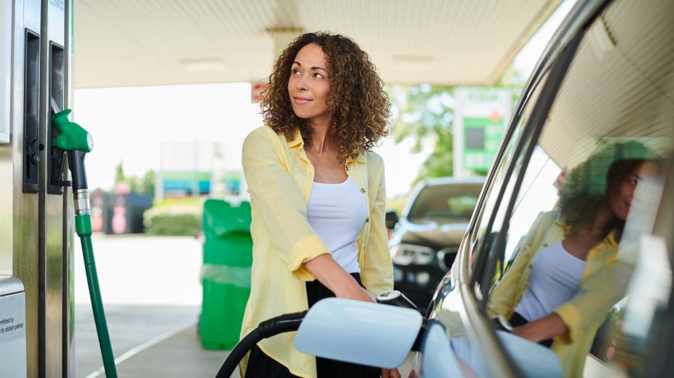Woman filling car with fuel
